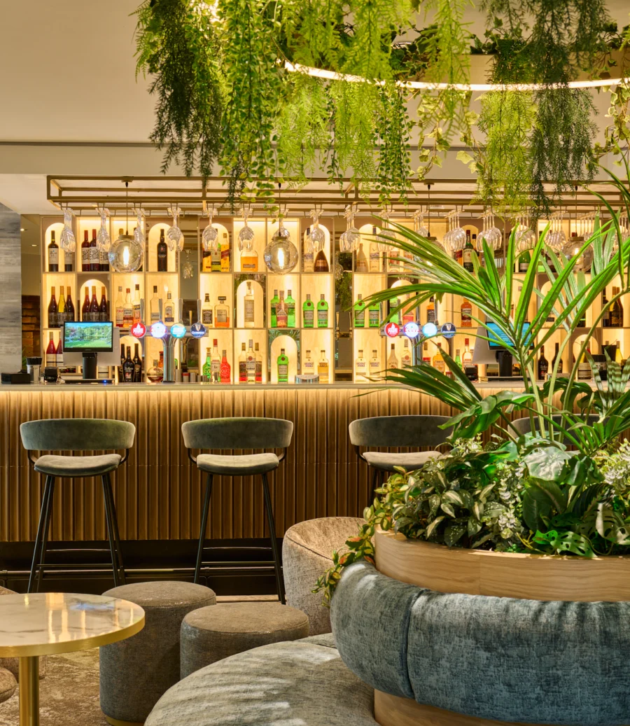 Bar and lounge with hanging greenery, ready for a private event
