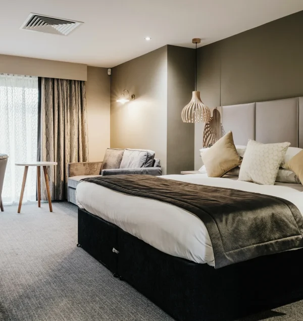 Boutique spa suite with a king-size bed and soft lighting
