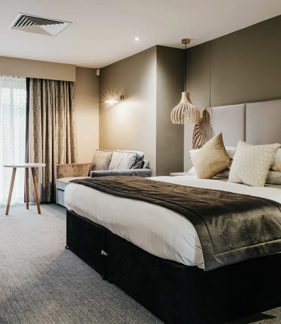Boutique spa suite with a king-size bed and soft lighting